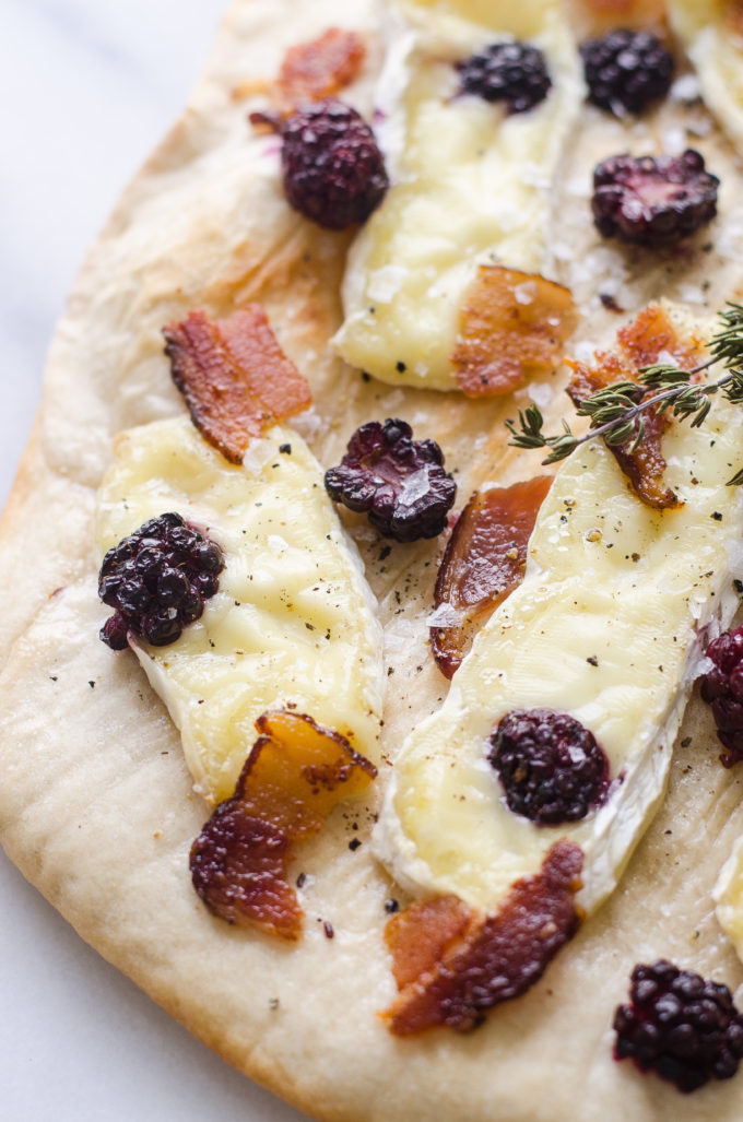 Homemade pizza with blackberries, brie, and baocn