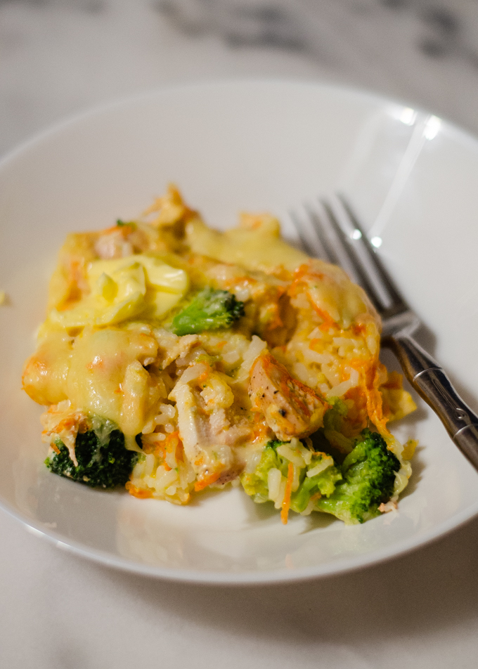 Cheesy chicken and broccoli casserole in a bowl with a fork.