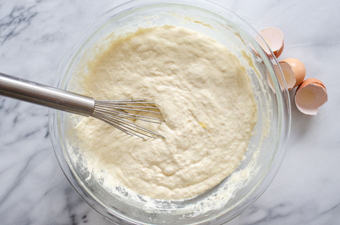 The final batter in a large bowl on a marble surface.