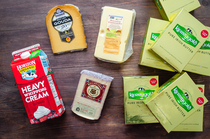 All of the dairy products we bought at Costco laid out on a wooden surface.