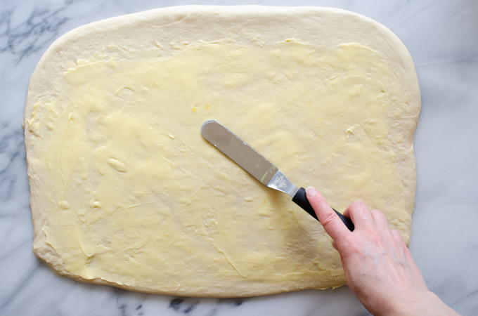 Spreading the dough with soft butter.