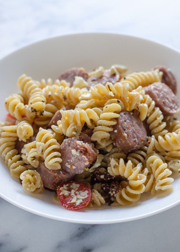 A pasta bowl filled with sausage, feta, and sundried tomato pasta. Just one of 5 family dinner ideas!