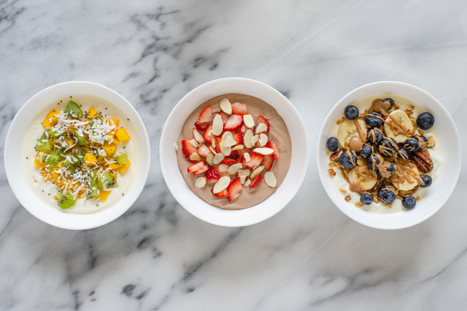 Three yogurt bowl ideas: tropical, strawberry, and granola.