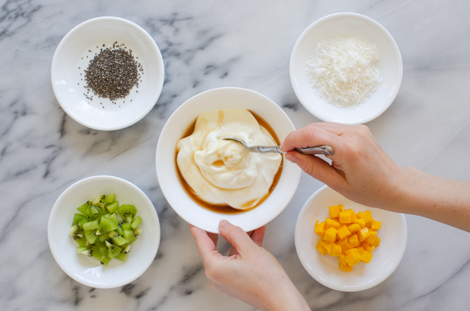 Mixing maple syrup into Greek yogurt.