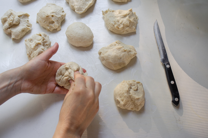 Pinching the corners of the dough into the middle.