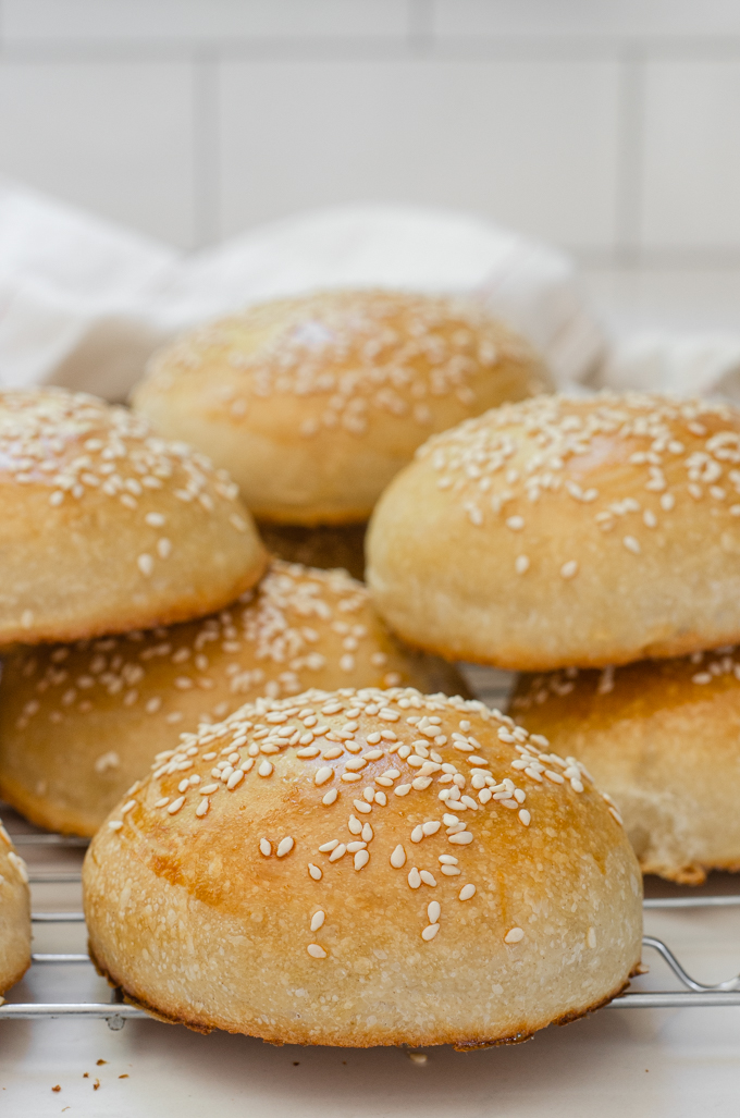 Sourdough hamburger buns with sesame seeds sprinkled on top.