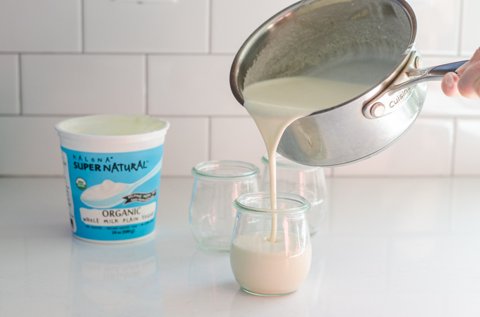 Pouring the yogurt panna cotta into individual serving jars.