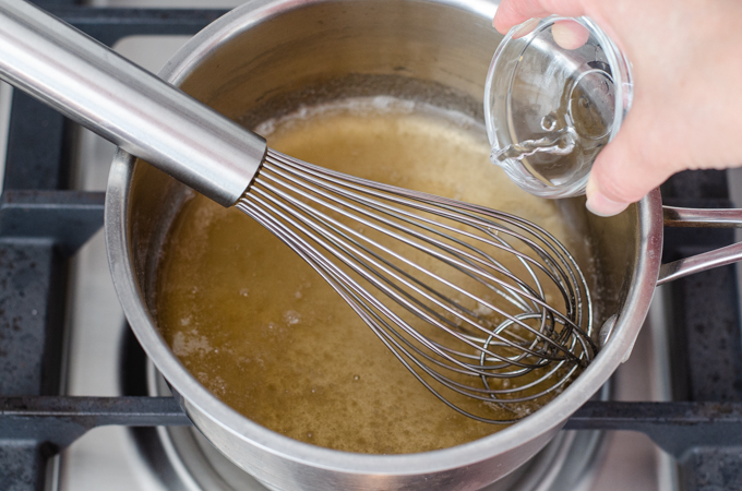 Adding the water to the saucepan.