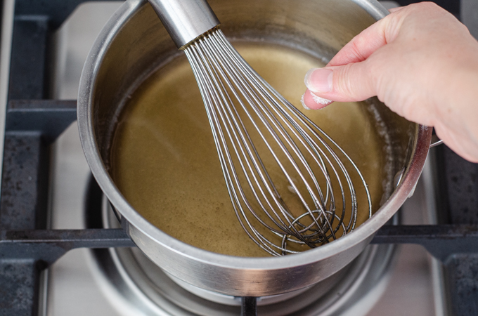 Sprinkling the salt into the saucepan.