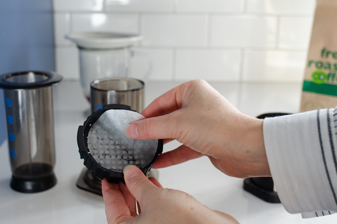 Placing the paper filter in the aeropress.