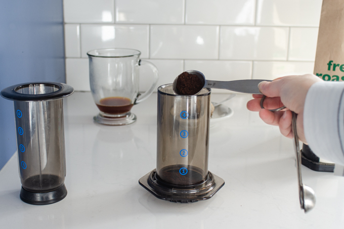 Adding the ground coffee to the aeropress.