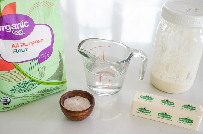 All of the ingredients for sourdough tortillas laid out on a counter.