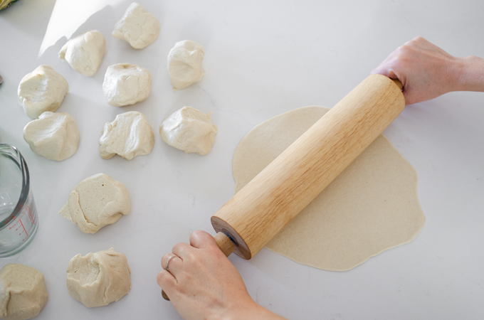 Rolling out the dough for sourdough tortillas.