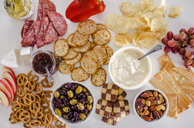 A bunch of different snacks laid out on a white counter.