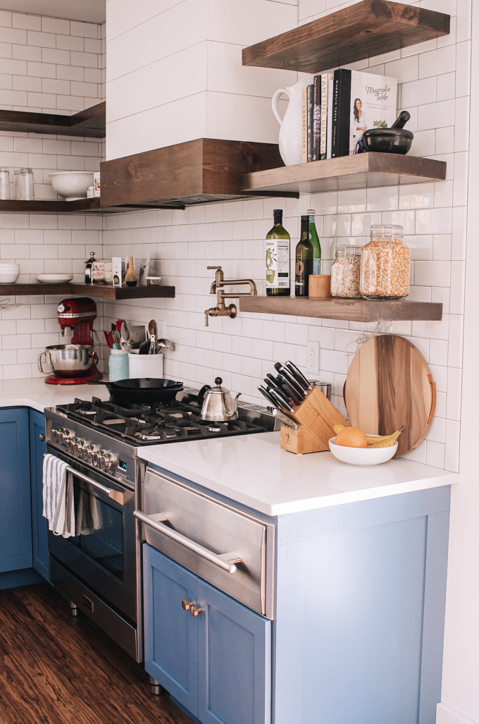 Warming drawer next to a stainless steel range. 