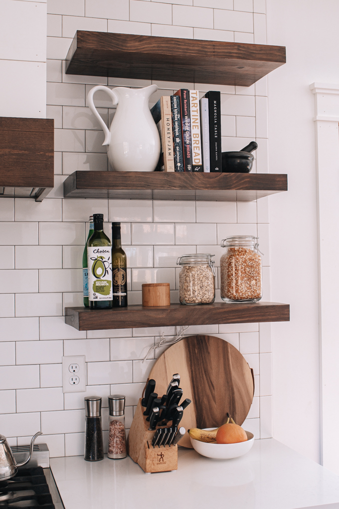 Open shelves styled with cookbooks and jars.