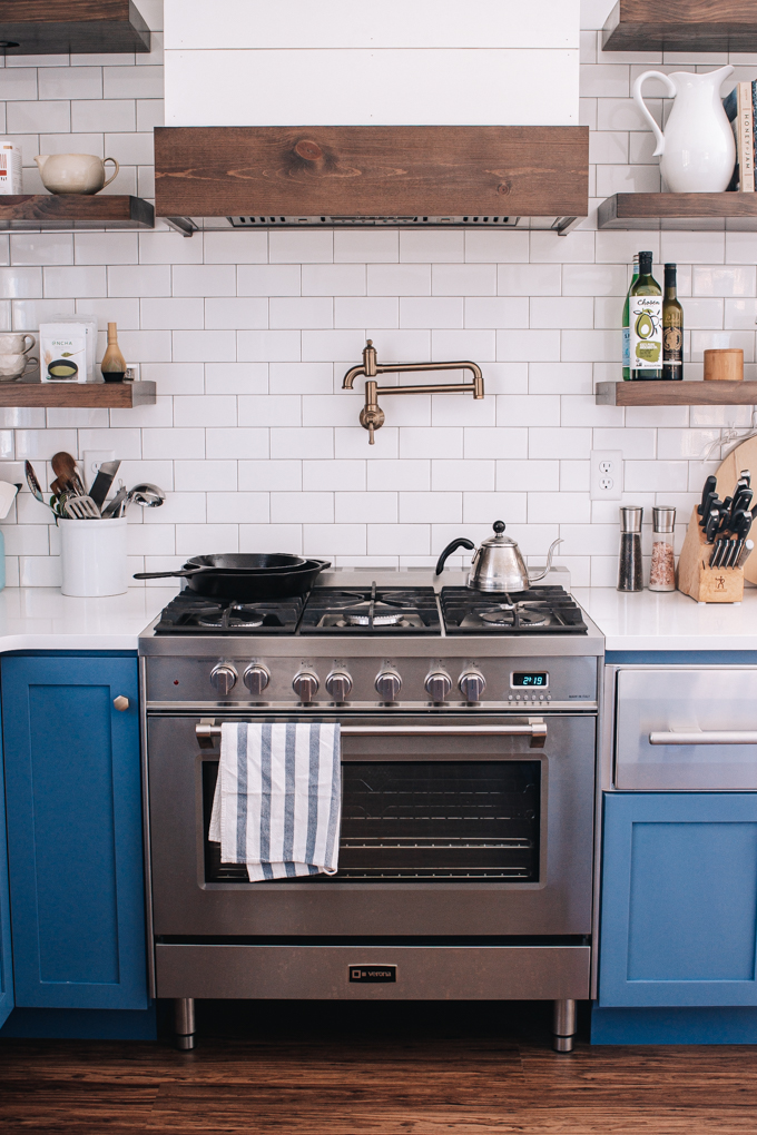 Verona Prestige Dual Fuel 36" range with Delta Broderick pot filler and custom range hood.