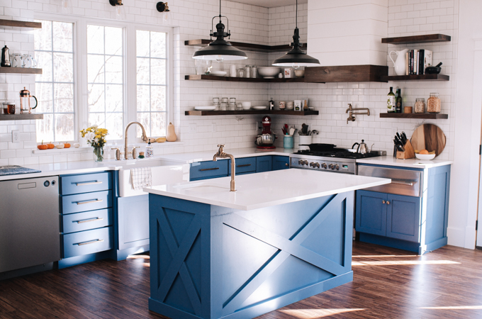 1.5 m Blue kitchen island with white countertops and decorative cross on front and sides.