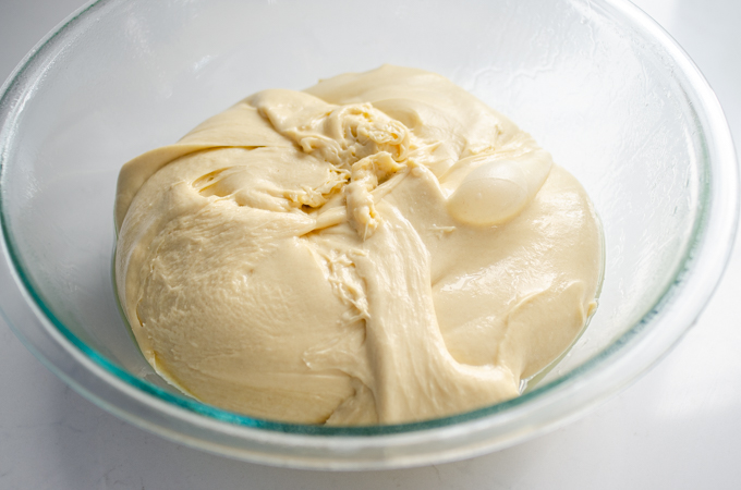 The ball of dough placed in a greased bowl.