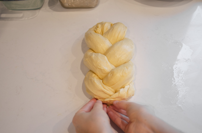 Pinching the ends of the braid to secure.