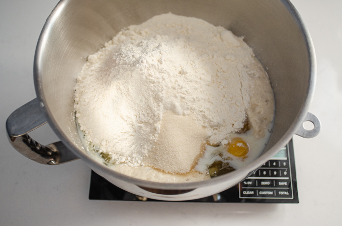 Adding the flour and sugar to the stand mixer bowl.