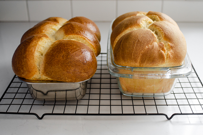 The baked loaves of sourdough brioche cooling on a wire rack.