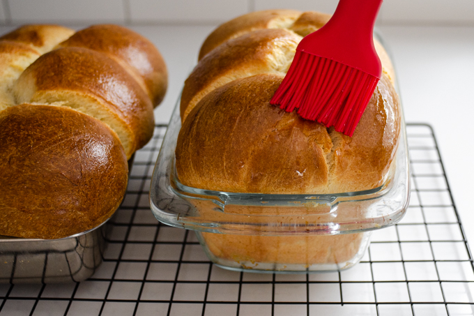 Brushing the warm loaf with the vanilla simple syrup.