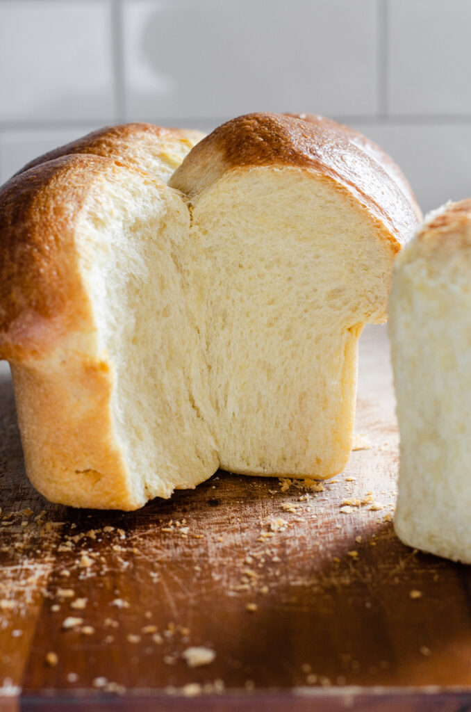 Sourdough brioche bun bread with a section taken out.