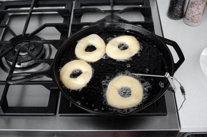 Frying the sourdough doughnuts in avocado oil.