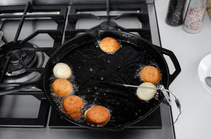 Flipping the doughnut holes.