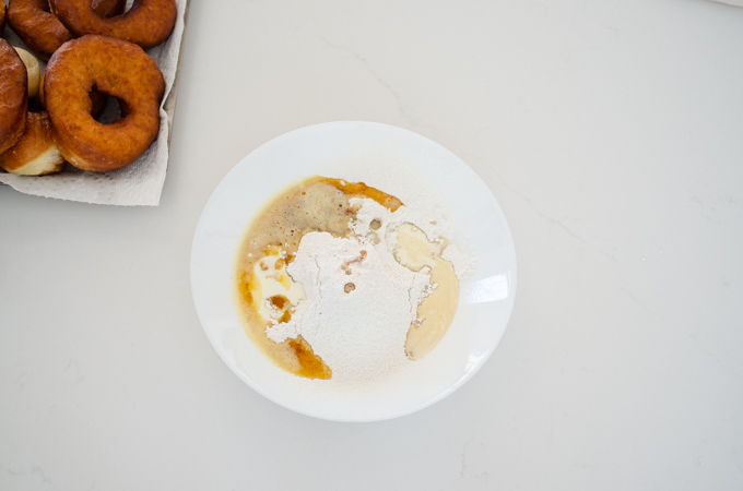 All of the ingredients for the frosting for this sourdough donut recipe in a small bowl.