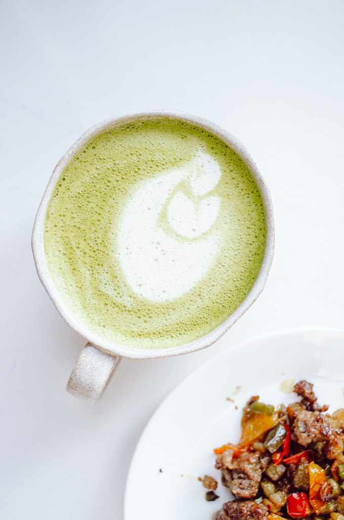 A mug of matcha oat milk latte.