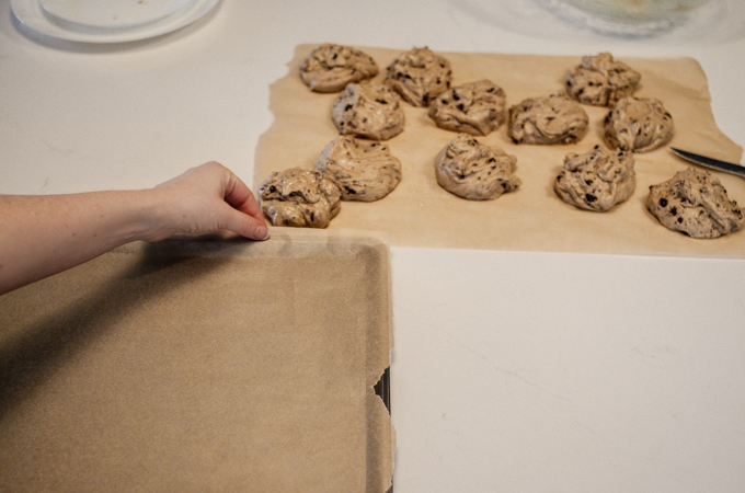 Lining a rimmed baking sheet with parchment paper.