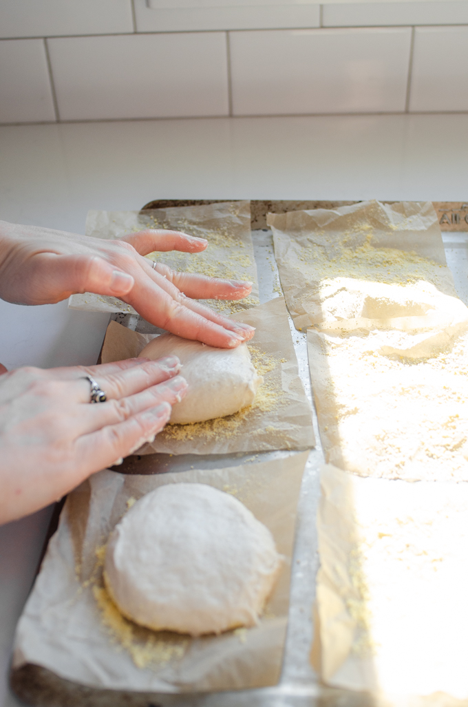 Flattening out the balls of dough.
